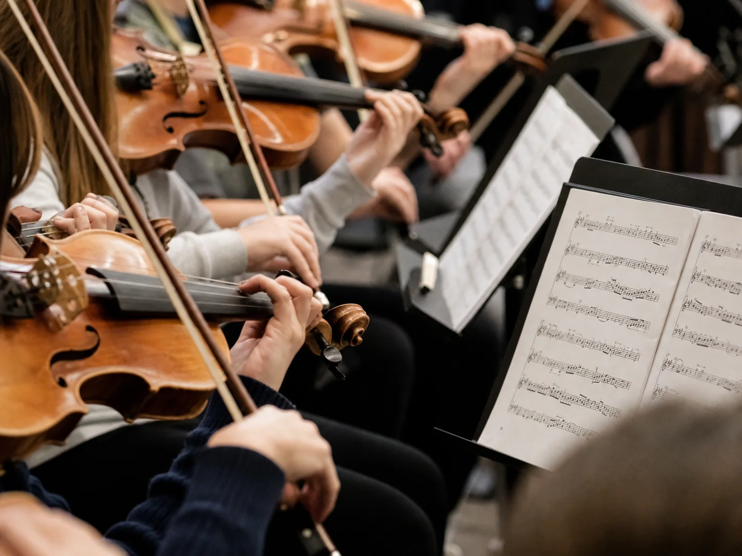 String players rehearsing with music stands